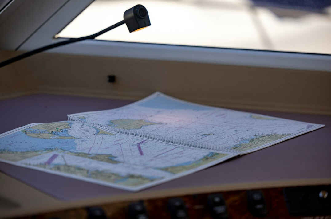 Close-up of investigative research documents, charts and annotated maps on a desk