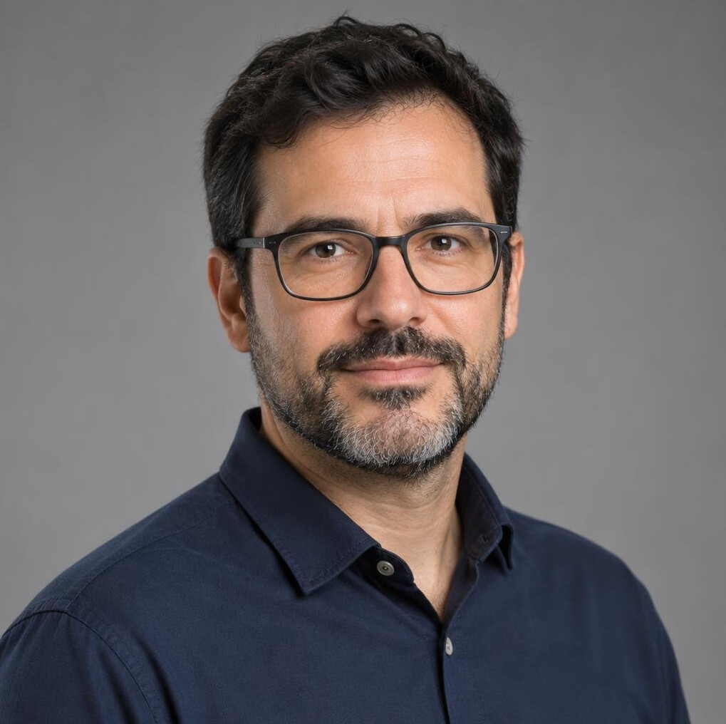 Studio portrait of a Portuguese male data journalist in his early 40s